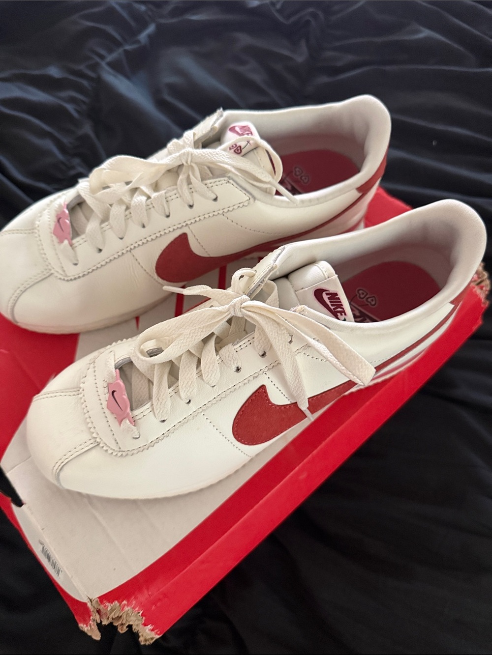 Nike Women’s White Leather Sneakers with Red Swoosh and Pink Lace Accents